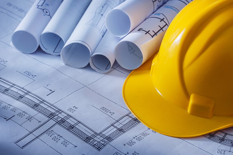 Rolled Blueprints And Construction Helmet