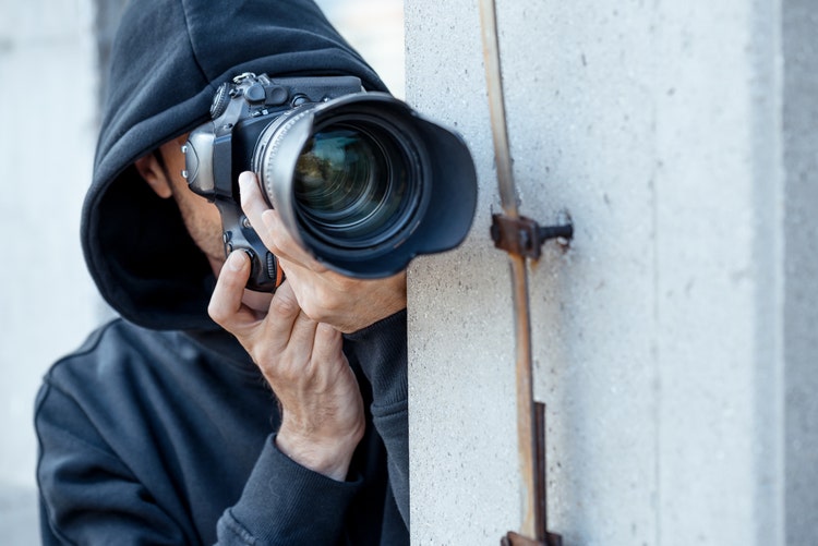 Spy at work. Man with photo camera.