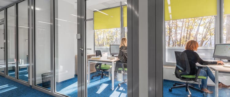 Modern and light office interior with glass wall
