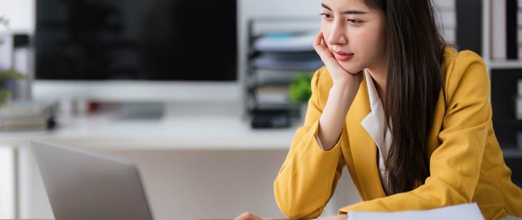 asian business woman thinking solving problem at work, worried serious young asian woman concerned make difficult decision lost in thought reflecting sit with laptop.
