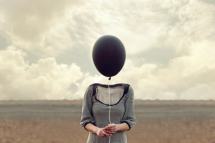 woman's head replaced by a black balloon
