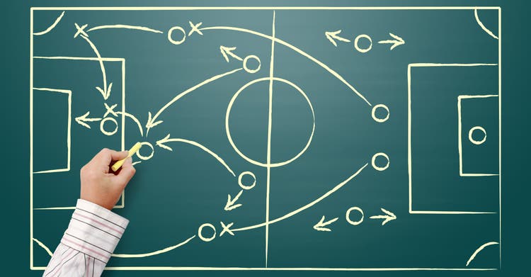 Cropped Hand Of Person Writing On Blackboard